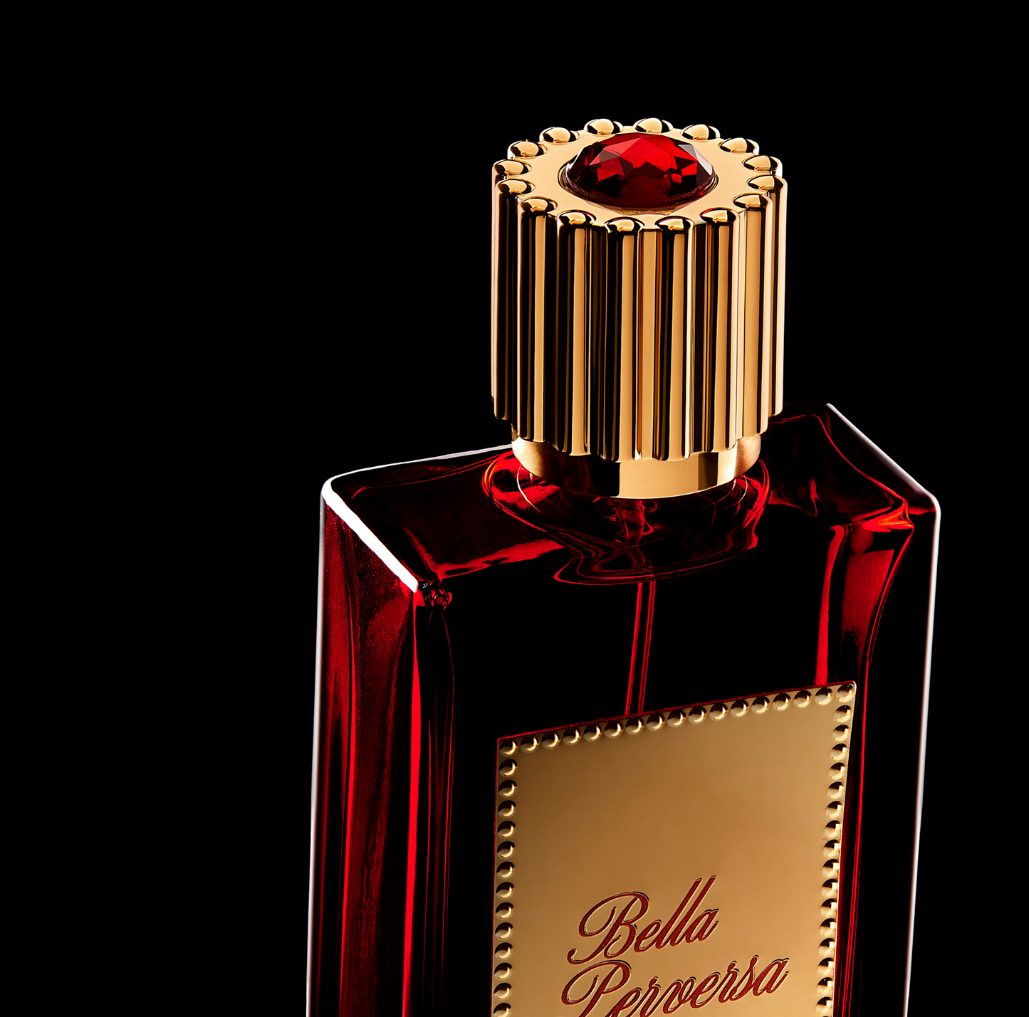 Close-up of the cap on Scarlet Eau de Parfum highlighting the red gem atop the cap.