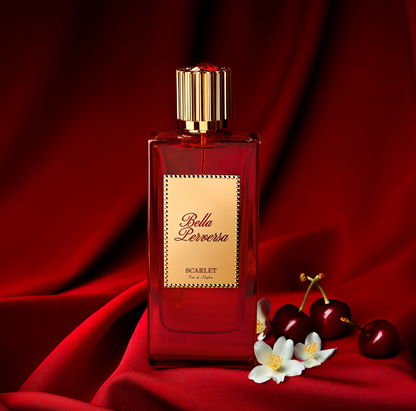 Scarlet Eau de Parfum by Bella Perversa, created by influencer Daisy Marquez, 2.5 fl oz, displayed alongside two of its key notes of bing cherries and jasmine flowers.