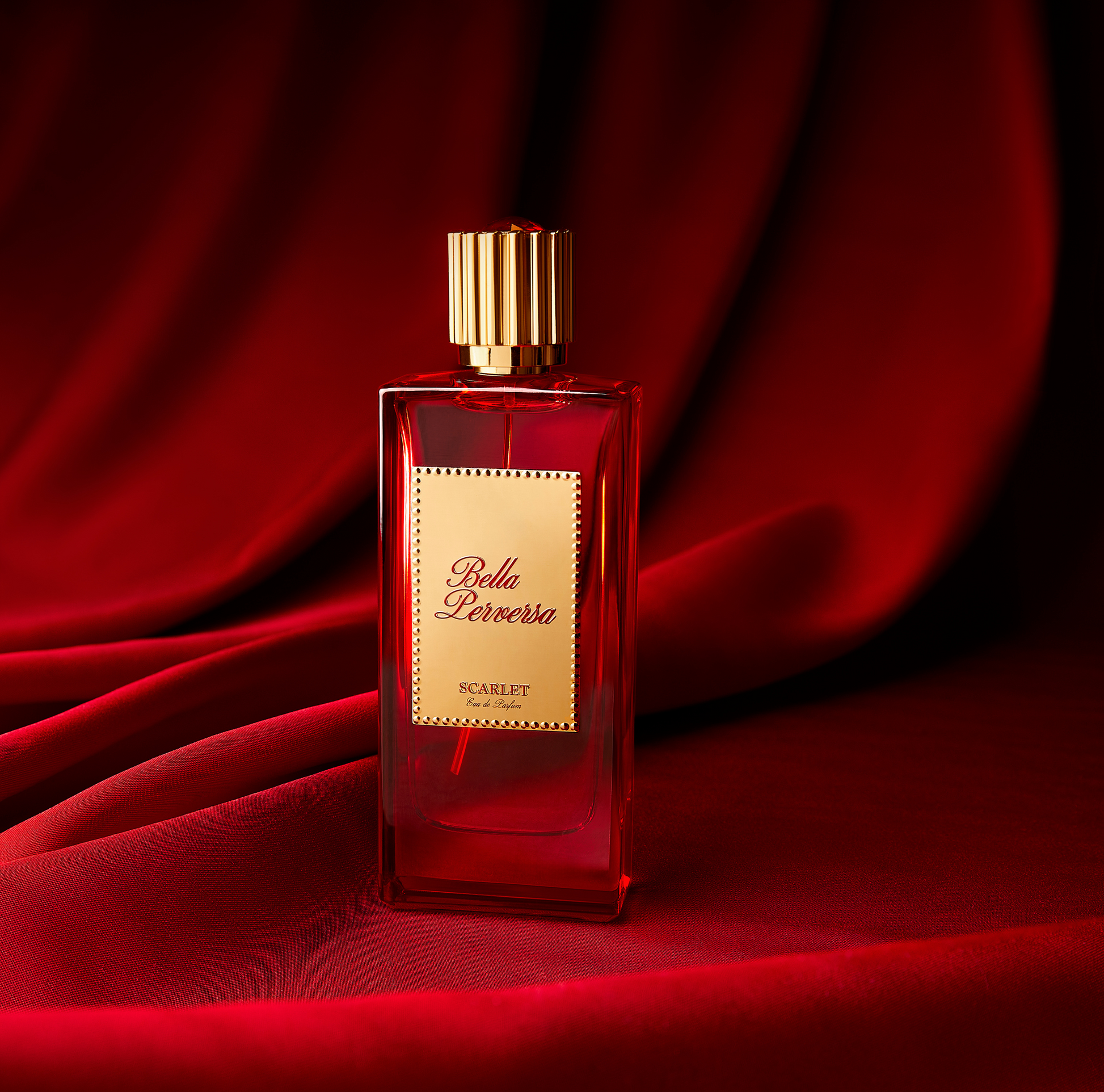 Scarlet Eau de Parfum 2.5 fl oz displayed against a red draped curtain.